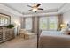 This spacious bedroom features natural light, a ceiling fan, sitting area, and neutral décor at 463 Old Piedmont Cir, Chapel Hill, NC 27516