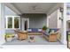Relaxing covered patio featuring comfortable furniture, ceiling fan and outdoor decor at 463 Old Piedmont Cir, Chapel Hill, NC 27516
