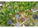 Overhead view of a home nestled among green trees, showcasing its private setting at 48 Arabella Ln, Clayton, NC 27520