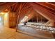 Exposed beams and insulation show the spacious attic space at 48 Arabella Ln, Clayton, NC 27520