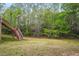 Backyard with stairs leading to a wooded lot at 48 Arabella Ln, Clayton, NC 27520
