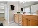 Bathroom features wooden cabinetry, dual sinks, and a large mirror at 48 Arabella Ln, Clayton, NC 27520