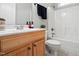 Bathroom featuring wood cabinets, sink, toilet, and shower with gray walls at 48 Arabella Ln, Clayton, NC 27520