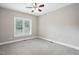 Bedroom with neutral carpet, ceiling fan, and large window at 48 Arabella Ln, Clayton, NC 27520
