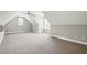 Spacious carpeted bonus room with bright windows, ceiling fan, and sloped ceilings at 48 Arabella Ln, Clayton, NC 27520