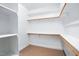 Walk-in closet with wood rods and shelving at 48 Arabella Ln, Clayton, NC 27520
