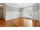 Formal dining room with hardwood floors, classic wainscoting, and a large window at 48 Arabella Ln, Clayton, NC 27520