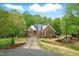 Beautiful exterior view of brick home, landscaped front yard, and a winding driveway at 48 Arabella Ln, Clayton, NC 27520