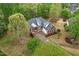 Aerial view of a two-story brick home with dormers and mature landscaping at 48 Arabella Ln, Clayton, NC 27520