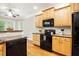 Kitchen showcasing stainless steel appliances, ample cabinets, and views to a breakfast bar at 48 Arabella Ln, Clayton, NC 27520
