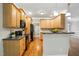 Kitchen with wood cabinets, dark countertops, and stainless steel appliances with a view to living area at 48 Arabella Ln, Clayton, NC 27520