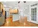 Open kitchen with wood cabinets, dark counters, and stainless appliances, leading into the dining space at 48 Arabella Ln, Clayton, NC 27520