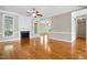 Spacious living room showcasing hardwood floors, fireplace and large windows at 48 Arabella Ln, Clayton, NC 27520