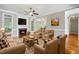 Comfortable living room featuring a fireplace, hardwood floors, and natural light at 48 Arabella Ln, Clayton, NC 27520