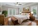 Comfortable main bedroom with hardwood floors, ceiling fan, and outside view at 48 Arabella Ln, Clayton, NC 27520