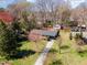 Aerial view of a charming home with a long driveway, spacious lawn, and mature landscaping at 5033 Green Oak Dr, Durham, NC 27712