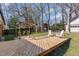 Backyard featuring a wooden deck, pergola, treehouse and white Adirondack chairs at 5033 Green Oak Dr, Durham, NC 27712