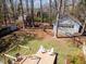 Aerial view of the backyard deck with pergola and seating, plus a playhouse and garage at 5033 Green Oak Dr, Durham, NC 27712