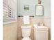 A quaint bathroom featuring a toilet, sink with vanity, and a mirror with natural light from a window at 5033 Green Oak Dr, Durham, NC 27712