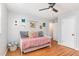 Comfortable bedroom featuring a daybed, hardwood floors, decorations, and natural light at 5033 Green Oak Dr, Durham, NC 27712