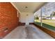 The carport features brick columns, a concrete floor, and a closed white door at 5033 Green Oak Dr, Durham, NC 27712