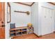 Cozy entryway featuring a built-in bench with storage, coat hooks, and a closet for organization at 5033 Green Oak Dr, Durham, NC 27712