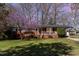 Charming home with a manicured lawn, lovely landscaping, and an inviting front porch at 5033 Green Oak Dr, Durham, NC 27712
