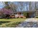 Charming one-story brick home with well-manicured lawn and appealing flowering tree in the front yard at 5033 Green Oak Dr, Durham, NC 27712