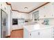 Well-lit kitchen with white cabinets, stainless steel appliances, and a breakfast bar at 5033 Green Oak Dr, Durham, NC 27712