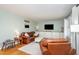 Comfortable living room with hardwood floors, leather furniture, and built-in cabinets at 5033 Green Oak Dr, Durham, NC 27712
