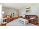 Well-lit living room with hardwood floors, classic furniture, and a decorative mirror at 5033 Green Oak Dr, Durham, NC 27712