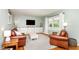 Bright living room featuring hardwood floors, large windows and cozy leather seating at 5033 Green Oak Dr, Durham, NC 27712