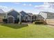 Backyard of house features a patio, shed, and well-maintained lawn at 504 Skygrove Dr, Holly Springs, NC 27540