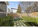 A relaxing backyard swing with comfortable cushions and lush landscaping at 504 Skygrove Dr, Holly Springs, NC 27540