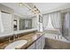 Elegant primary bathroom with double sinks, granite countertops, soaking tub, and glass-enclosed shower at 504 Skygrove Dr, Holly Springs, NC 27540