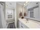 Neutral bathroom with single vanity, large mirror, and a shower with tiled walls at 504 Skygrove Dr, Holly Springs, NC 27540