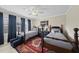 Charming bedroom with two twin beds, ceiling fan, and red area rug over neutral carpeting at 504 Skygrove Dr, Holly Springs, NC 27540