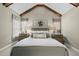 Vaulted ceiling primary bedroom with rustic wood beam detail, neutral color palette, and bright, natural light at 504 Skygrove Dr, Holly Springs, NC 27540