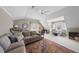 Large bonus room with carpet, multiple seating areas, and bright natural light at 504 Skygrove Dr, Holly Springs, NC 27540