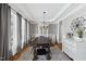 Elegant dining room with hardwood floors, large windows, and stylish chandelier at 504 Skygrove Dr, Holly Springs, NC 27540