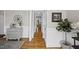 Hallway with hardwood floors, detailed trim, and views into other rooms at 504 Skygrove Dr, Holly Springs, NC 27540