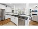 Beautiful kitchen featuring white cabinets, black countertops, and stainless steel appliances at 504 Skygrove Dr, Holly Springs, NC 27540