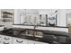 Modern kitchen featuring granite countertops, stainless steel sink, and white cabinetry at 504 Skygrove Dr, Holly Springs, NC 27540