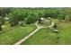 Picturesque rural property featuring a well-maintained home, barns, a serene pond, and expansive green pastures at 5069 Cokesbury Rd, Fuquay Varina, NC 27526