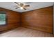 A bedroom with wood paneled walls and flooring at 5069 Cokesbury Rd, Fuquay Varina, NC 27526
