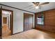 Bedroom with wood paneled walls, wood floor and closet at 5069 Cokesbury Rd, Fuquay Varina, NC 27526