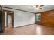 Bedroom featuring hardwood floors, a ceiling fan, and wood paneling at 5069 Cokesbury Rd, Fuquay Varina, NC 27526