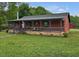 Cozy home with a covered porch, flag, and stone foundation, offering classic country charm at 5069 Cokesbury Rd, Fuquay Varina, NC 27526