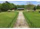 Spacious front yard featuring a long driveway leading to a charming home and lush greenery at 5069 Cokesbury Rd, Fuquay Varina, NC 27526