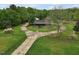 Charming home with a circular driveway and lush green lawn, providing a serene setting at 5069 Cokesbury Rd, Fuquay Varina, NC 27526